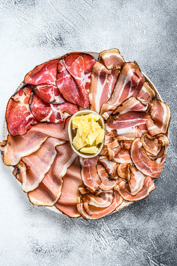 Set of cold cured italian meat Ham, prosciutto, pancetta, bacon. White