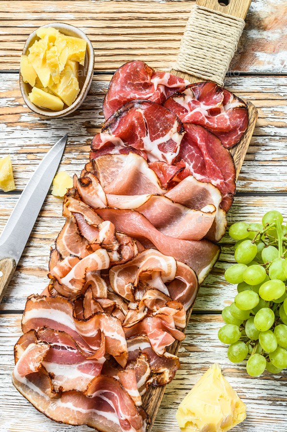 Set of cold cured italian meat Ham, prosciutto, pancetta, bacon. White