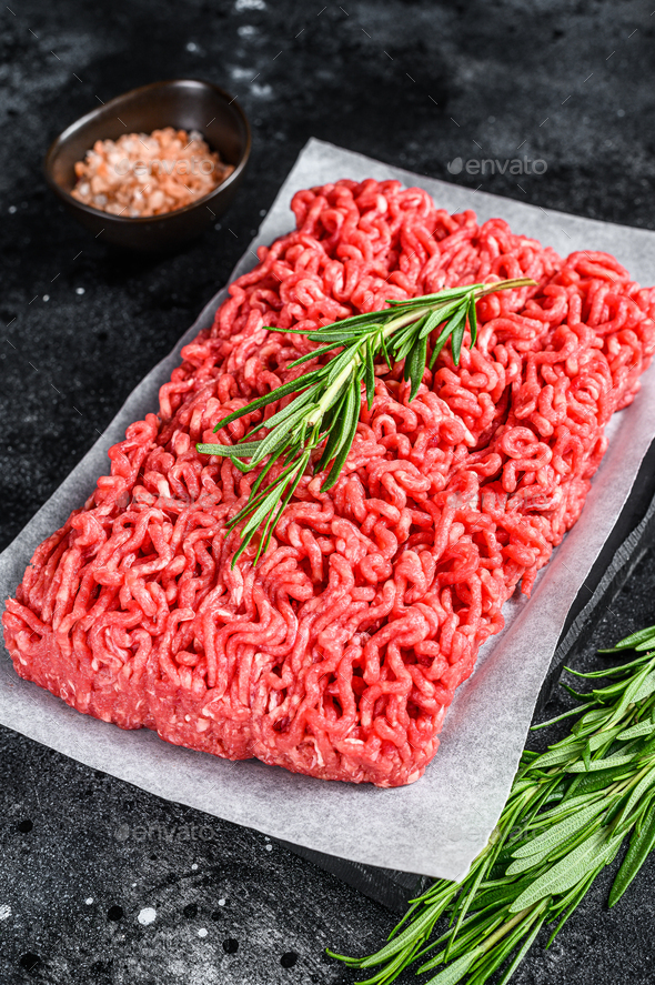 Fresh Raw mince beef, ground meat on butcher paper. Black background ...