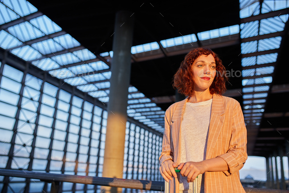 Smiling attractive young female at station - Stock Photo - Images