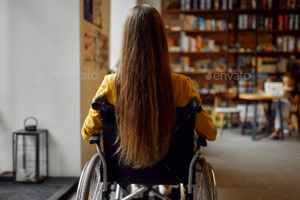 Disabled female student in wheelchair, back view - Stock Photo - Images