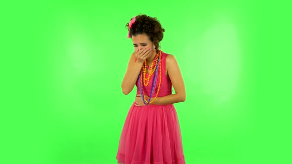 Cute Female Feels Very Bad, Her Stomach Hurts, Feeling Nausea Against Green Screen at Studio. alt