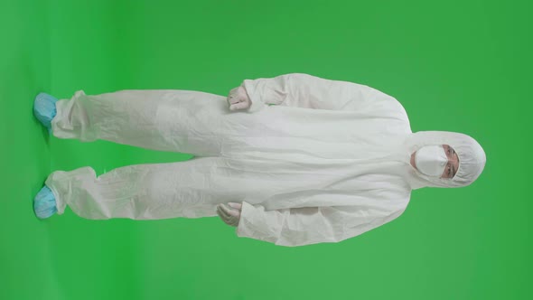 Asian Man Wear Protective Uniform PPE Positively Shaking His Head In The Green Screen Studio alt