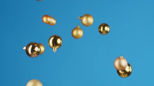 Flying Christmas Balls Against Blue Background