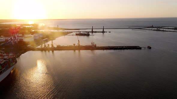 Aerial View of an Industrial Port with Cargo Ships with Containers at Sunset
