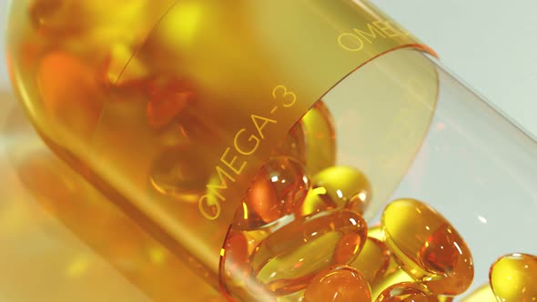 Big capsule filled with yellow, gel omega 3, fish oil or vitamin D pills.