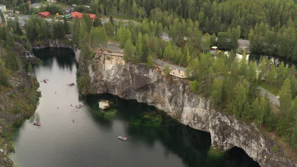 The drone flies high above the water in a marble canyon.