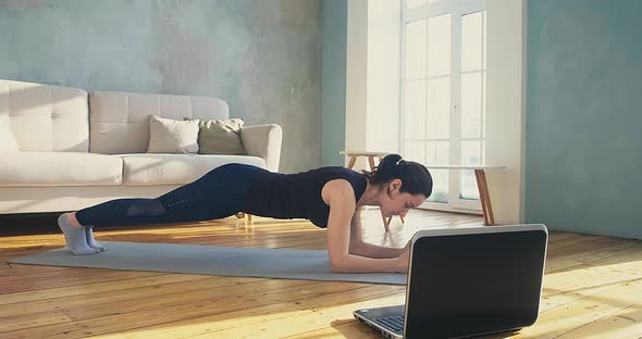 Woman Stands in Plank Pose alt