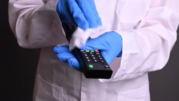 the Doctor Disinfects the TV Remote. Processing Things Against Viruses, Protecting the Home From alt