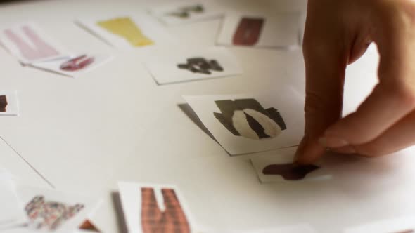 The Stylist Is Working on the Selection of the Image. Work with Paper Material in Style Selection