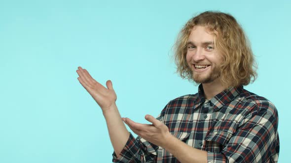 Slow Motion of Handsome Blond Guy Demonstrate Good Product Showing Promo and Thumbs Up Recommend