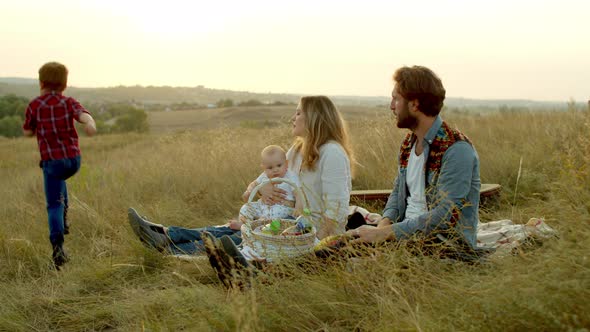 Parents Playing with Kids During Picnic in Field