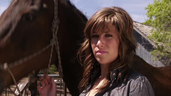 Slow motion shot of a woman with her horse. alt