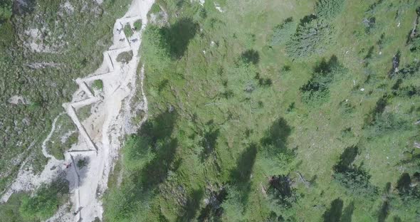Aerial drone view of a group of people hiking in the mountains alt