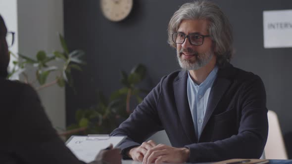 Cheerful Mid-Aged Businessman Smiling at Camera on Job Interview alt