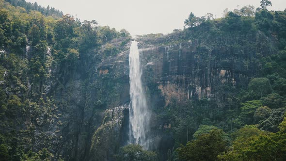 Beautiful Medium Shot, Landscape Background of Large Jungle Waterfall Rushing Down in Exotic alt