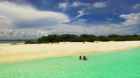 Ladies together happy together on beautiful coast beach lifestyle by clear sea and white sandy backg alt