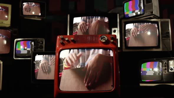 Man Hands of a Percussionist playing Peruvian Box on Retro TVs.