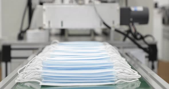 Heap Of Blue Disposable Medical Masks On Conveyor IIn Factory Ready For Packaging. - Close Up, Stati alt