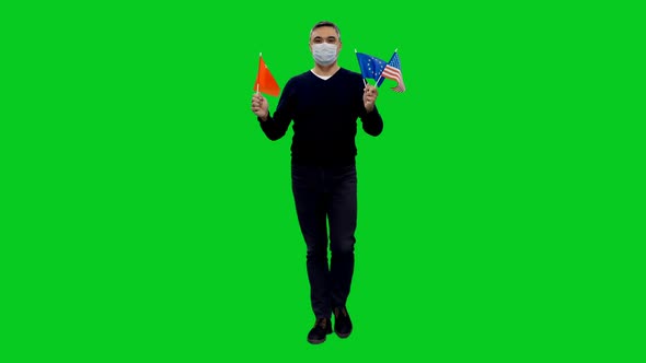 Adult Man Wearing Mask Stepping with Flags of China, EU and USA on Green Screen