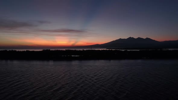 Aerial view of amazing sunset behind a mountain, Gili Trawangan, Indonesia. alt