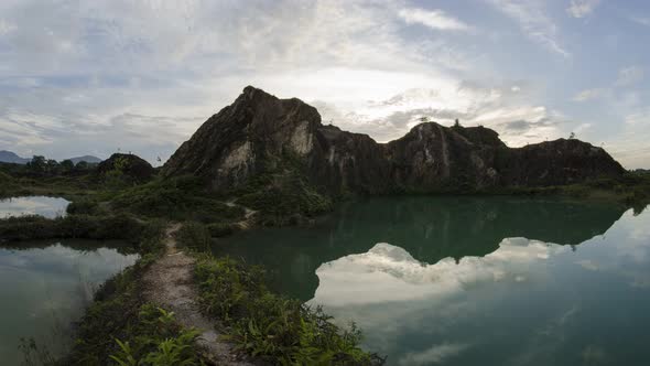 Timelapse road path towards the little hill of reflection sunset rocky mountain. alt