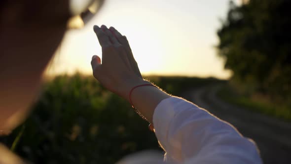 Woman's Hand Against The Sunset Sun, The Girl's Hand Touches The Sun, The Sun's Rays Through Her alt