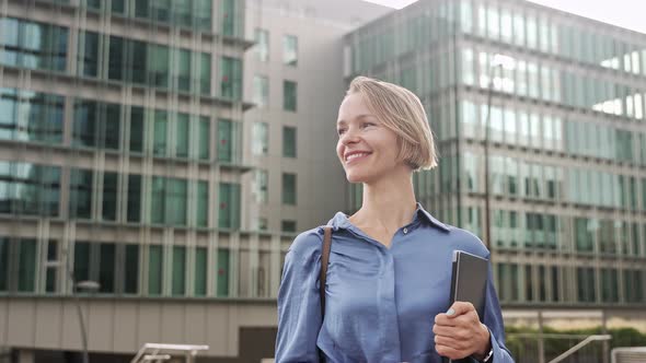 Confident Business Woman Walking in Outdoors Office City Carrying Laptop alt