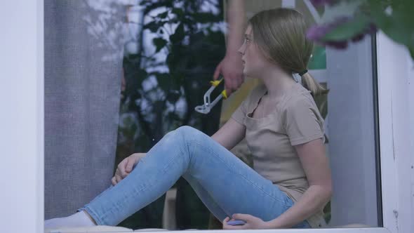 Scared Panicking Teenage Girl with Bruised Face Calling Emergency Social Service As Unrecognizable alt