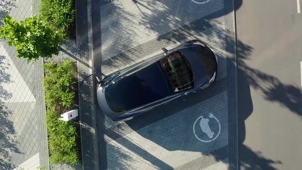 Aerial view of a white electric vehicle driving.  alt