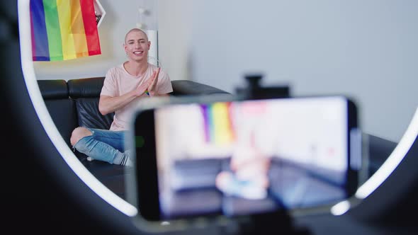 Happy Millenial Lgbtq Bold Man Vloging on Black Couch alt