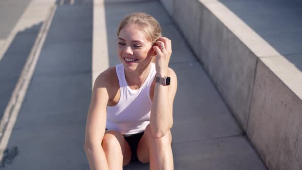 Smiling Woman Sitting on Stairs alt