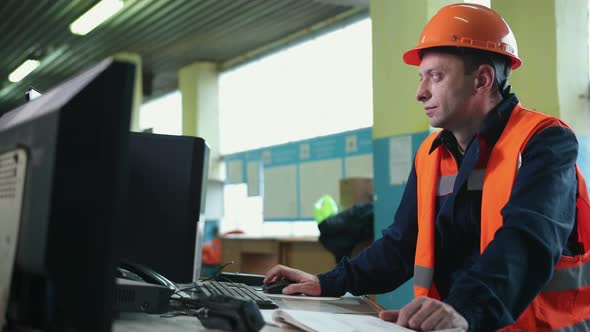 Heavy Industry Factory Male Industrial Engineer Works on Personal Computer alt