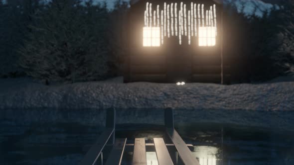 Illuminated Wooden Log Cabin Behind Frozen Lake alt