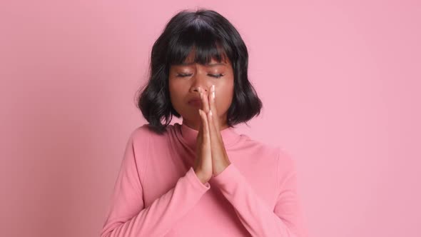 Dark Skinned Young Female Presses Palms and Makes Wish with Supplicating Face, Stock Footage