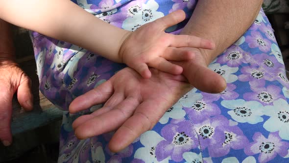Senior Woman Wrinkled Hands Touch and Clap Kid Hand. Closeup Hands of Grandchild and Grandmother