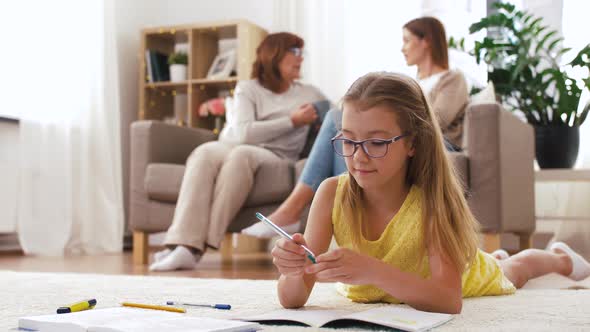 Student Girl with Notebook Lying on Floor at Home alt