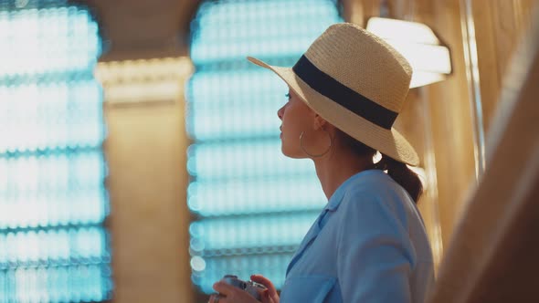 Young photographer takes a photo alt