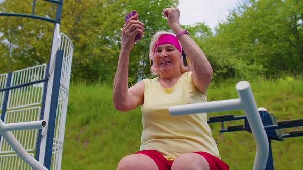 Senior Woman After Sport Training Listening Music on Playground Celebrate Win Doing Winner Gesture alt