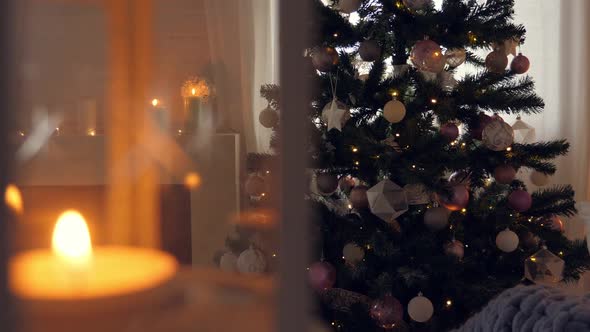 Burning Candles. Christmas Celebration in Cozy Interior with Decorated New Year Tree alt
