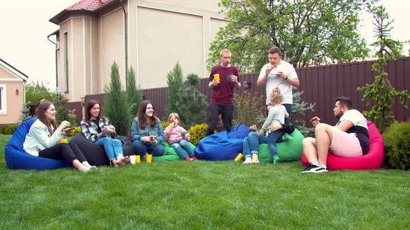 Friends Having Picnic in a Garden