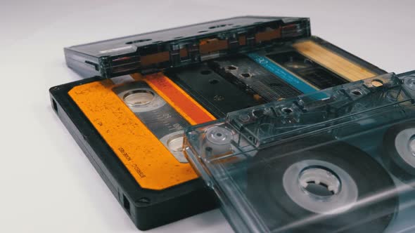 Four Audio Cassettes Rotate on White Background alt