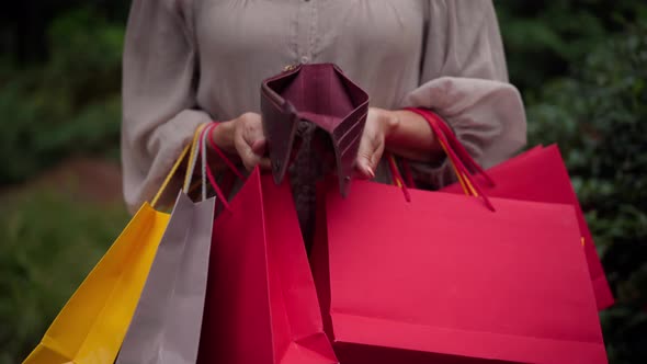 Unrecognizable Caucasian Senior Woman Opening Empty Wallet Showing No Money Inside alt