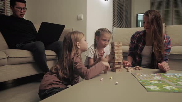 Family at home playing classic table games