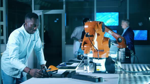 Diverse Team of Development Engineers Working with Robotic Mechanism in a Modern Laboratory alt