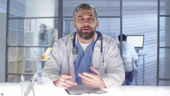 Caucasian Male Physician Asking Patient about Medical History alt