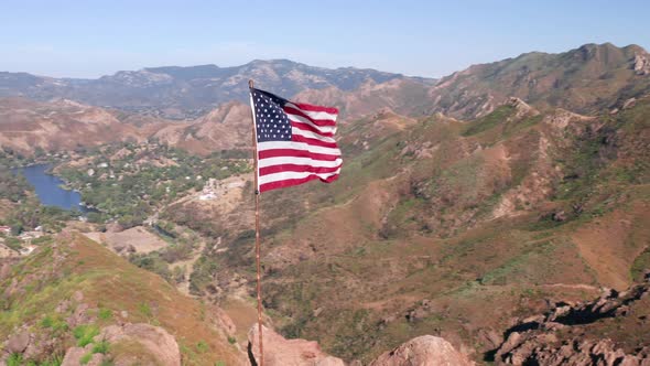 USA Flag on a Flagpole.  Aerial of the American Flag Is Fluttering on a Wind alt