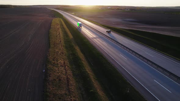 Cargo van with green screen and trackink markers on trailer drives along the highway. alt