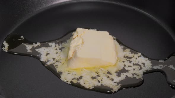 Timelapse  Stick of Butter Melting in Hot Black Frying Pan  Close Up