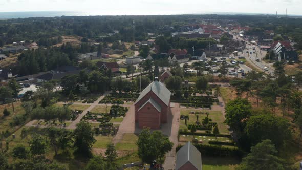 Aerial Footage of Cemetery Around Wooden Church or Chapel alt